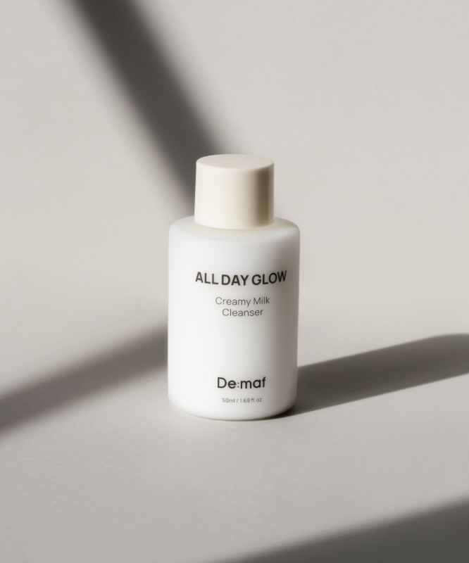 DE:MAF All Day Glow Creamy Milk Cleanser 50ml de De:maf, flacon de nettoyant visage sur fond minimaliste clair.