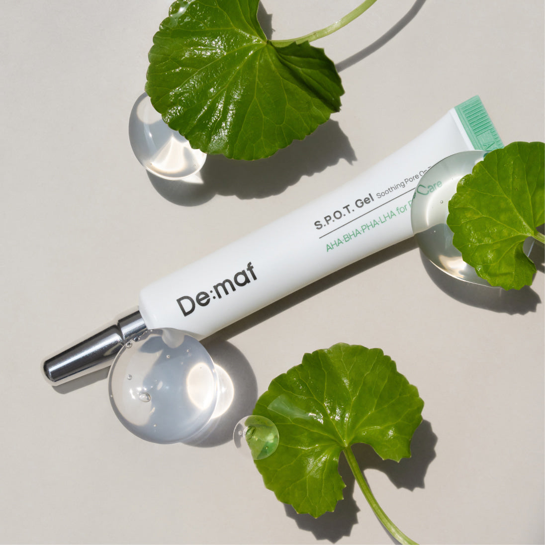 DE:MAF SPOT Gel Soothing Pore-On Treatment Gel 10g, marque De:maf, sur fond clair avec feuilles vertes.