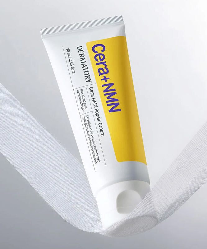 DERMATORY Cera NMN Repair Cream 70ml, tube sur tissu blanc, marque DERMATORY visible, crème réparatrice en contexte beauté