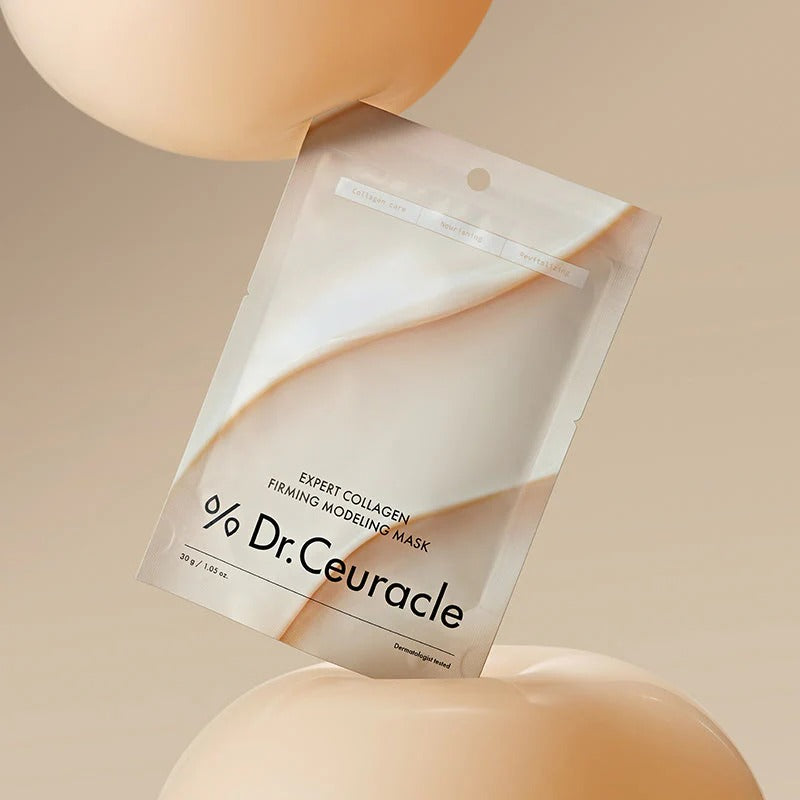 DR.CEURACLE Expert Collagen Firming Modeling Mask 30g de Dr.Ceuracle, sachet sur fond beige, contexte soin visage