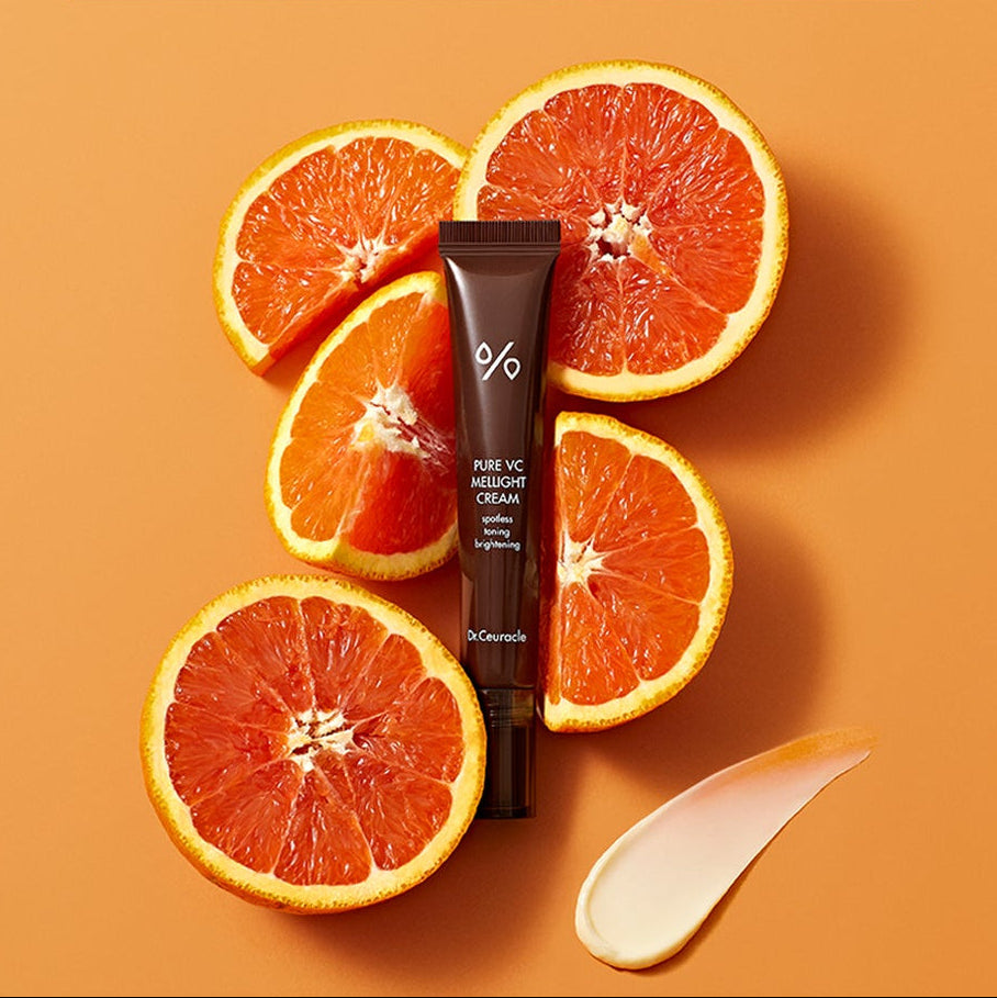 DR.CEURACLE Pure VC Melite Cream 20ml, tube crème sur fond orange avec tranches d’agrumes et crème.