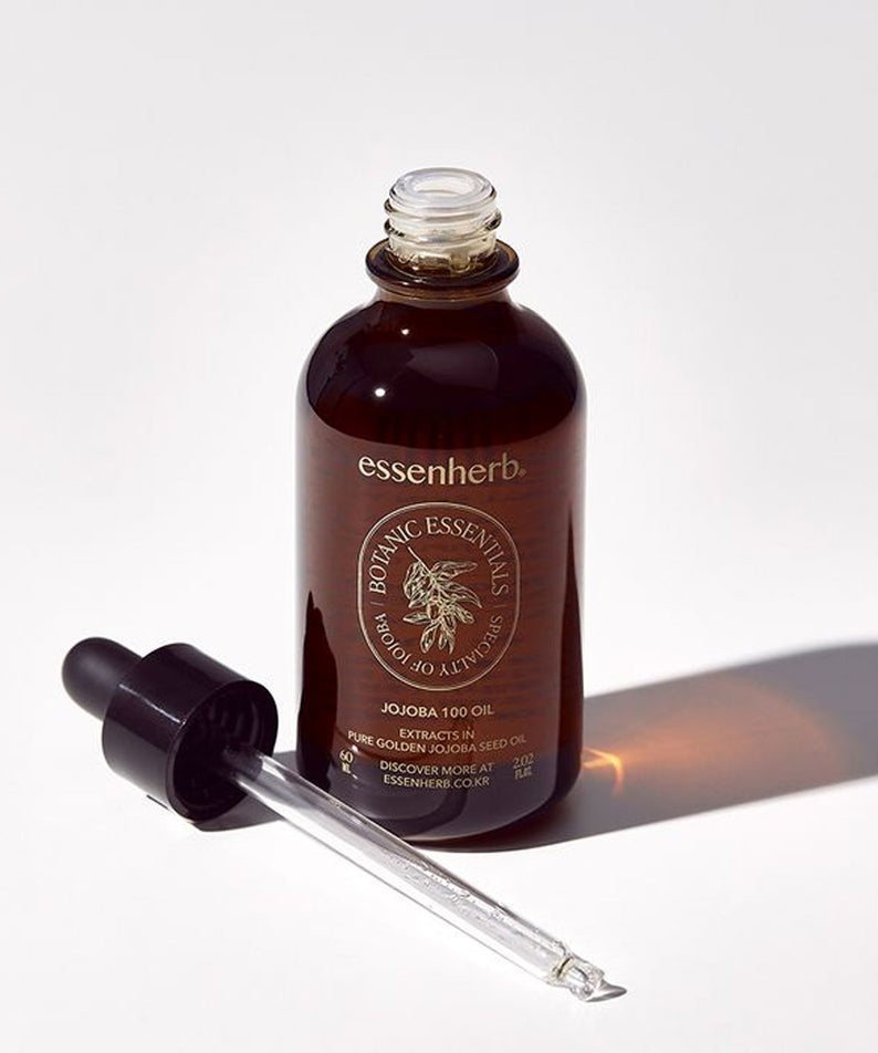 Bouteille de ESSENHERB Vegan Jojoba 100% Oil Unrefined Cold-Pressed 60ml avec pipette sur fond blanc.