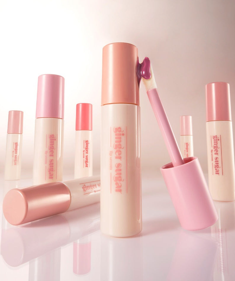 ETUDE Ginger Sugar Lip Serum 13g de la marque ETUDE, présentés en tubes rose avec application de sérum, sur fond clair.