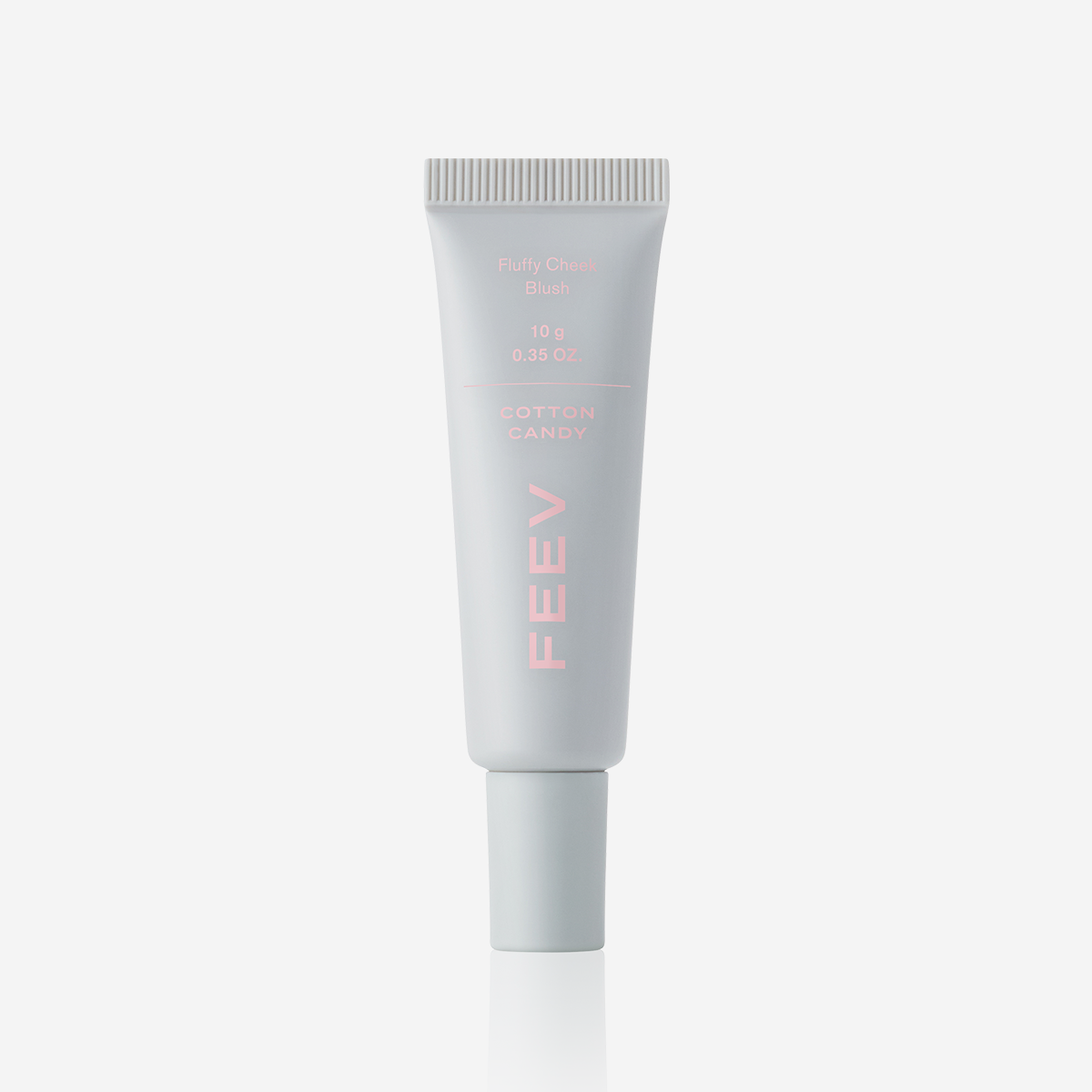 Décris l'image en français : FEEV Fluffy Cheek Blush 10g, tube cosmétique blanc sur fond clair, marque FEEV visible.
