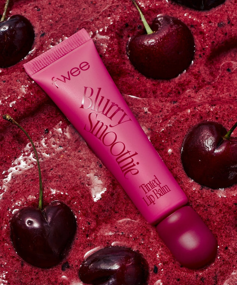 FWEE Glow Smoothie Tinted Lip Balm de la marque FWEE sur fond gourmand aux cerises, texture rose lustrée