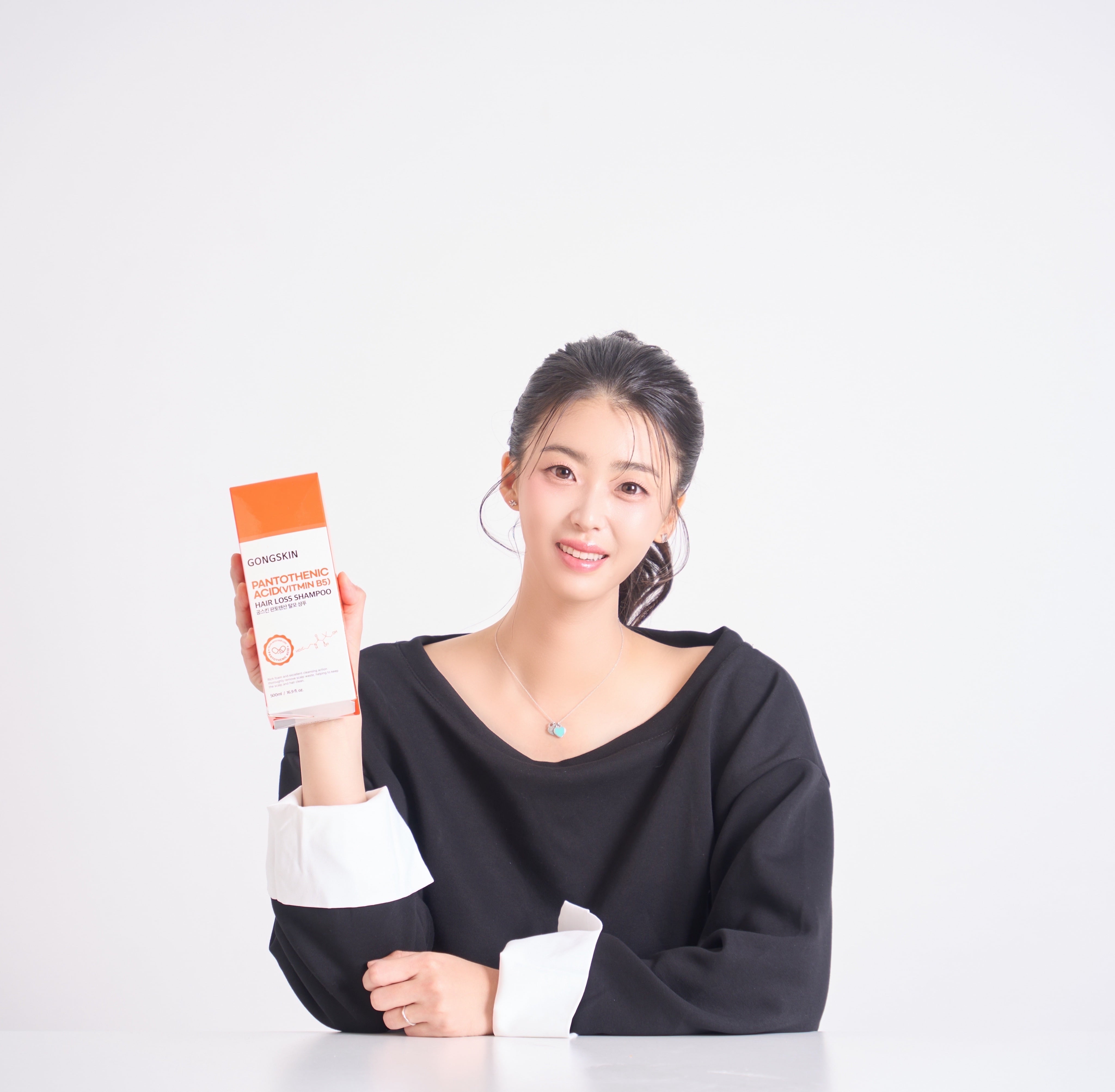 GONGSKIN Pantothenic Acid Hair Loss Shampoo 500ml en flacon, présenté par une femme sur fond clair