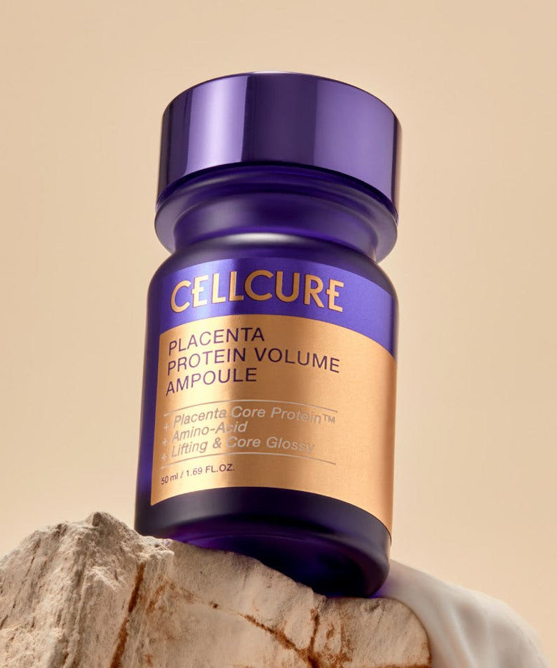 HANSKIN Placenta Protein Volume Ampoule 50ml de la marque HANSKIN, flacon violet sur fond beige, contexte beauté skincare.