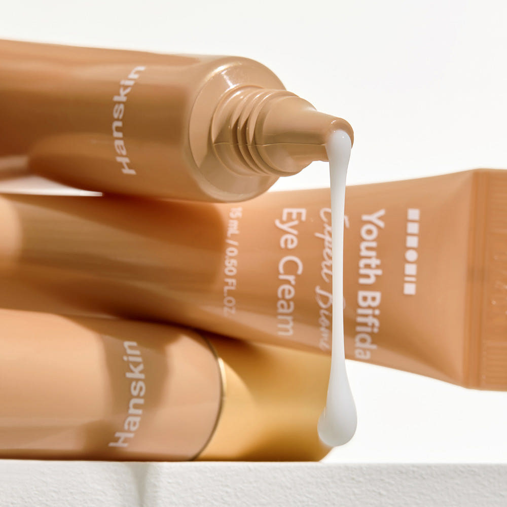 HANSKIN Youth Bifida Expert Biome Eye Cream 15ml : tube HANSKIN déversant une texture crème pour les yeux, gros plan.