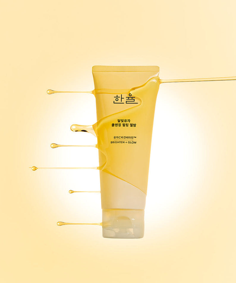HANYUL Yuja Brightening Peeling Gel Balm Cleanser 100g : gel baume citron, marque HANYUL sur fond jaune, gouttes visuelles.