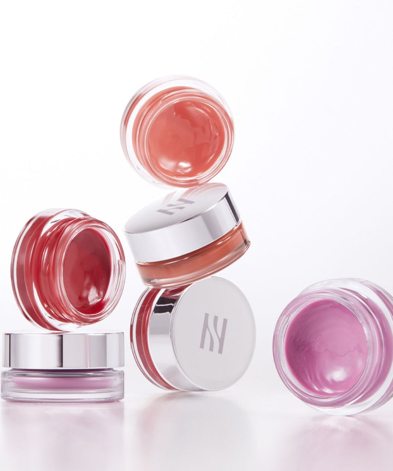 HERA Sensual Lip & Cheek 7g, baume lèvres et joues HERA, packaging rose sur fond blanc, pots et reflet lumineux.
