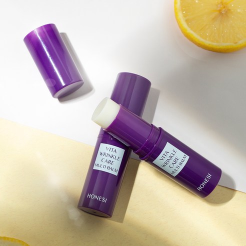 HONESI  Vita Wrinkle Care Multi Balm, baume anti-rides sur fond clair avec agrume et flacons violets