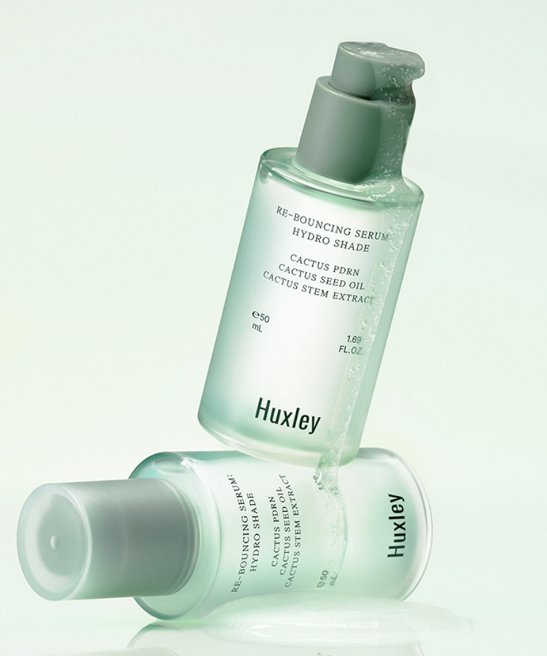 HUXLEY Rebouncing Serum Hydro Shade 50ml, photo produit flacon vert, marque Huxley, fond clair minimaliste, gouttes hydro.