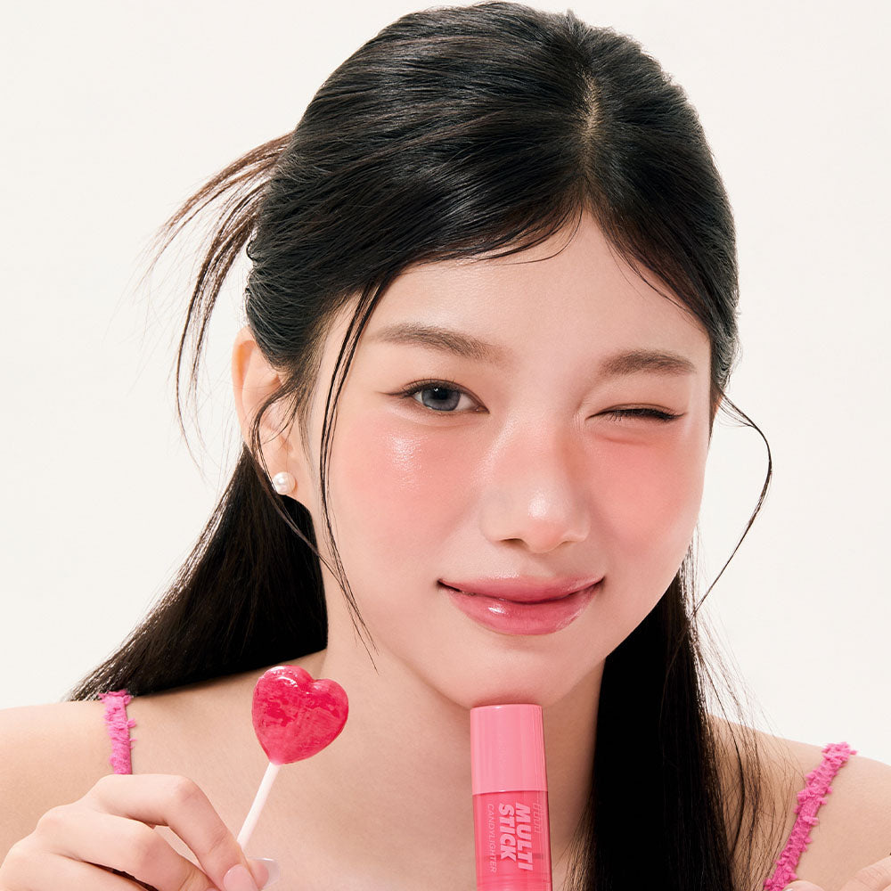 I'M MEME Multi-Stick Candy Lighter, marque I'M MEME : jeune femme souriante tient un bâton rosé et un bonbon