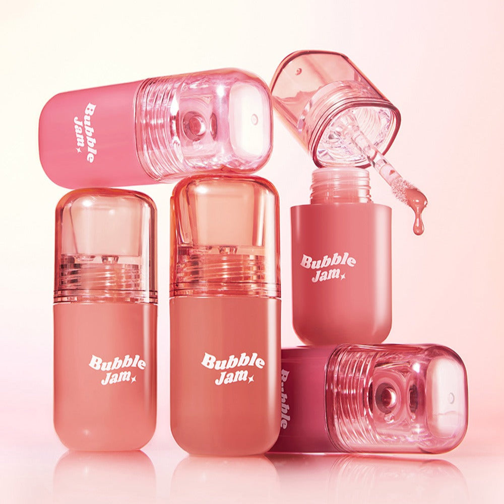 IPKN Bubble Jam Gloss, tubes brillants rose en arrière-plan pastel, photos produit de la marque IPKN.