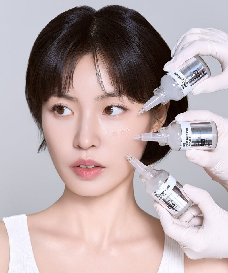 ISOI NDS Point Shot 2000 Ampoule 38ml, marque ISOI : application en esthétique par seringue sur visage, gants blancs.