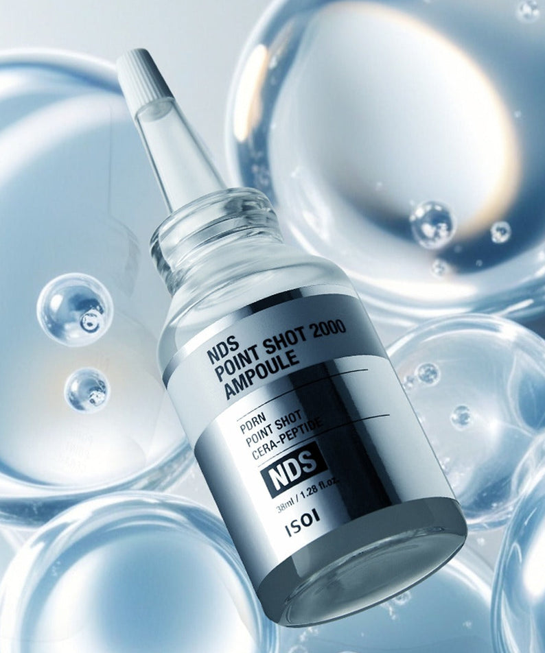 ISOI NDS Point Shot 2000 Ampoule 38ml, flacon d'élixir raffiné sur fond de bulles, produit de soin de peau avancé.