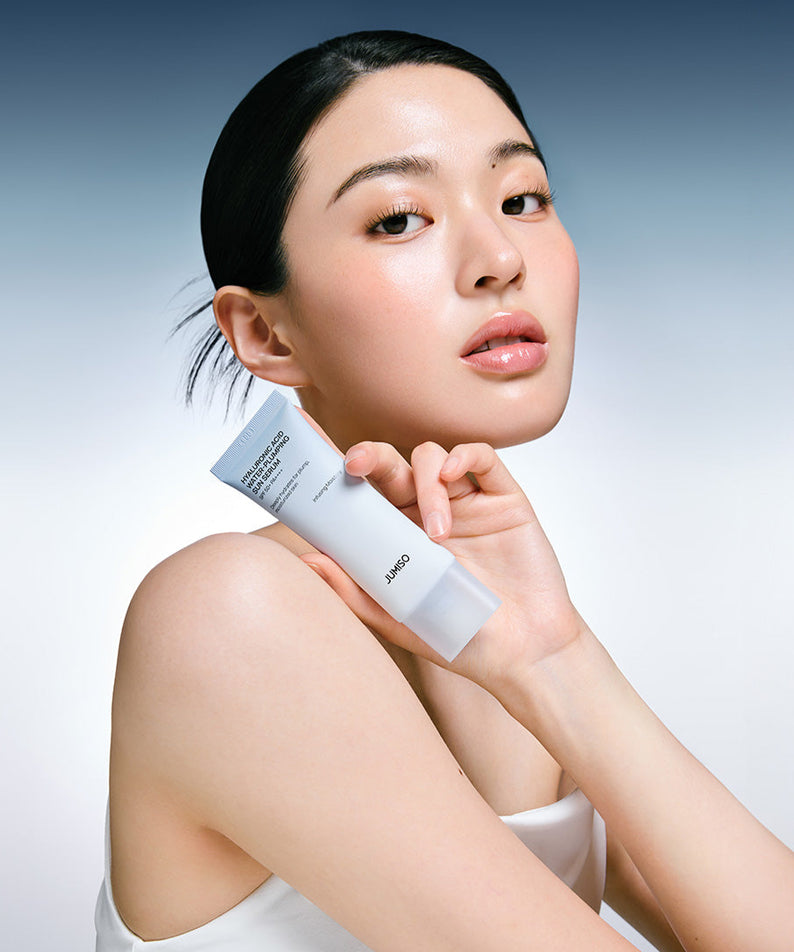 Femme tenant le JUMISO Hyaluronic Acid Water Plumping Moisture Sun Serum 40ml, parfait pour l'hydratation de la peau.