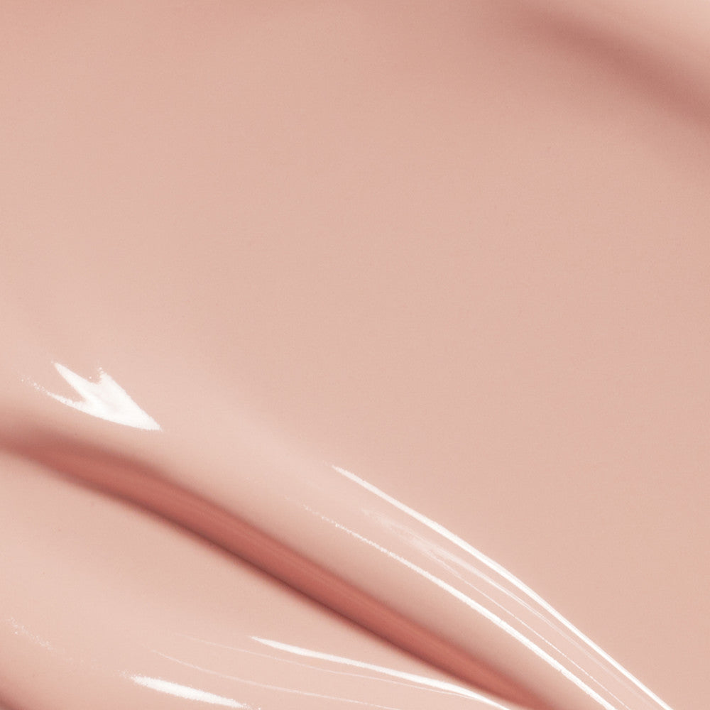 LAKA Bonding Tone-Up Base 30ml, flacon LAKA sur peau maquillée, texture rosée et luisante, gros plan