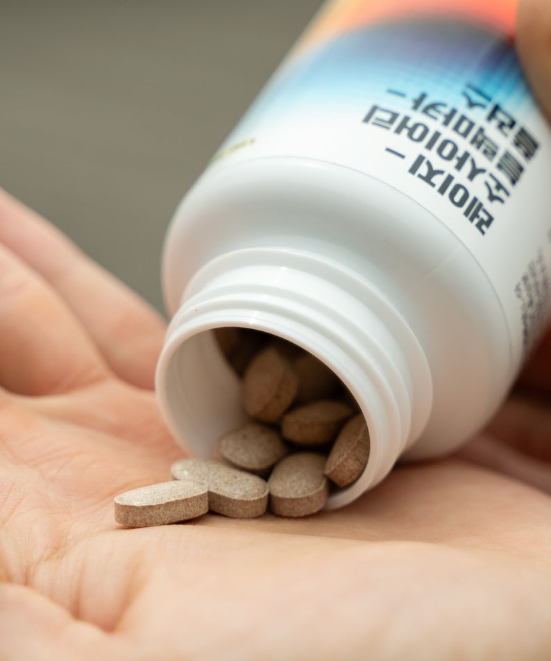 LAZY SOCIETY Black Maca Plus Supplement 120 Tablets : gélules brunes près d’un flacon blanc, mains, contexte produit.