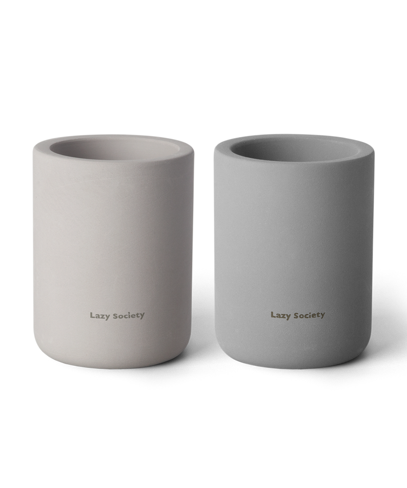 LAZY SOCIETY Diatomaceous Earth Holder 2.0 : deux supports en céramique sur fond noir, logo Lazy Society visible.