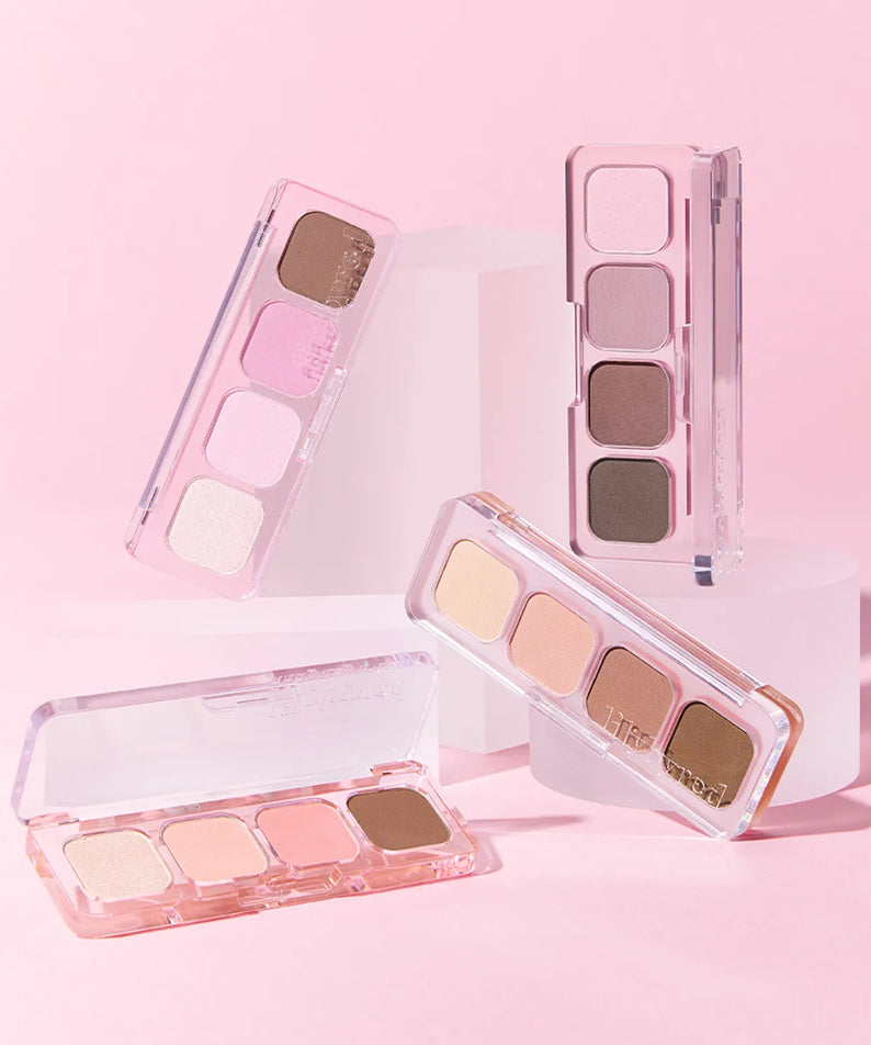Palettes LILYBYRED Mood It exposées sur fond rose, représentant des nuances douces et naturelles pour un maquillage subtil.
