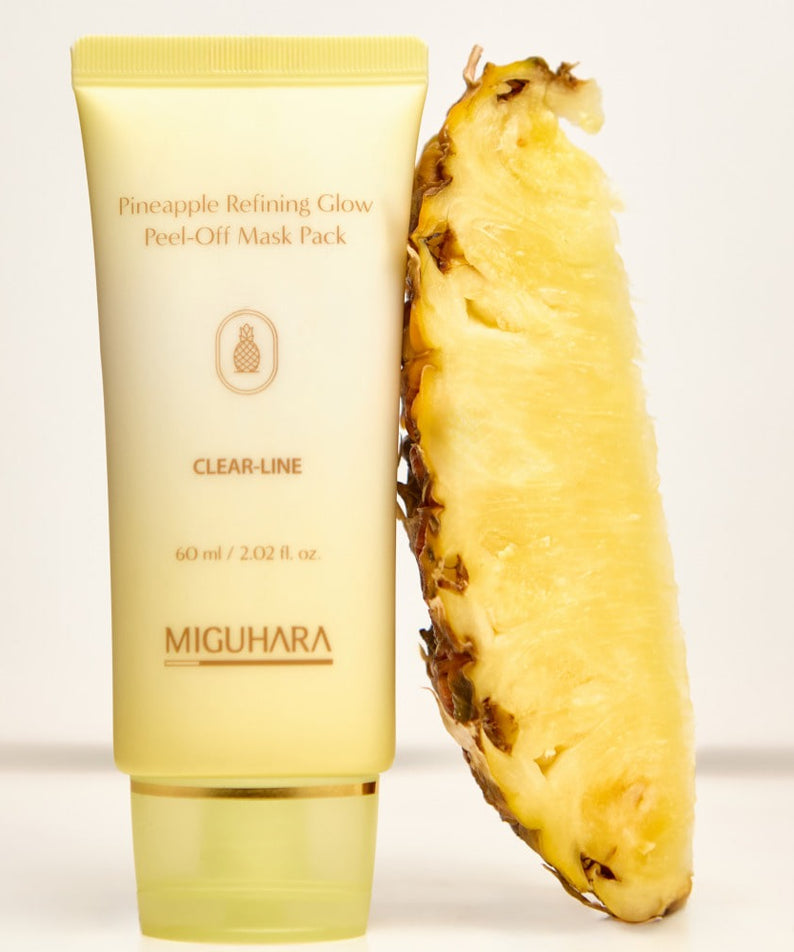 MIGUHARA Pineapple Refining Glow Peel Off Mask Pack 60ml à côté d'un ananas frais en tranches.