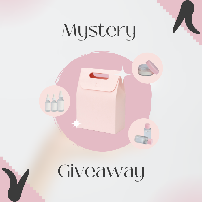 Mystery Gift : coffret surprise rose, flacons et maquillage, visuel promo giveaway, marque non spécifiée.