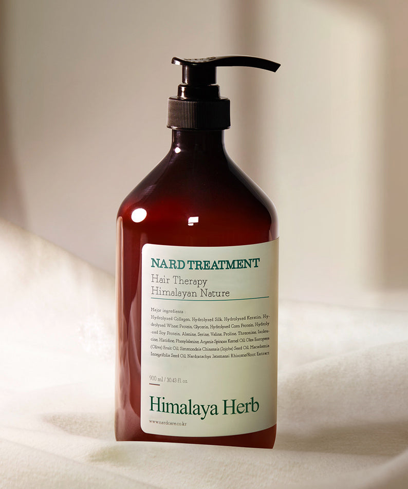 Décris l'image : NARD Rosemary Hair Treatment 1000ml de la marque NARD, flacon ambre sur fond clair, soin capillaire.