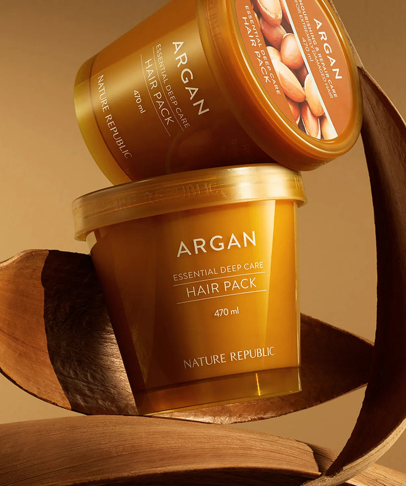 NATURE REPUBLIC Essential Deep Care Hair Pack 470ml, pot et rubans d’argan sur fond bois, photo produit en gros plan