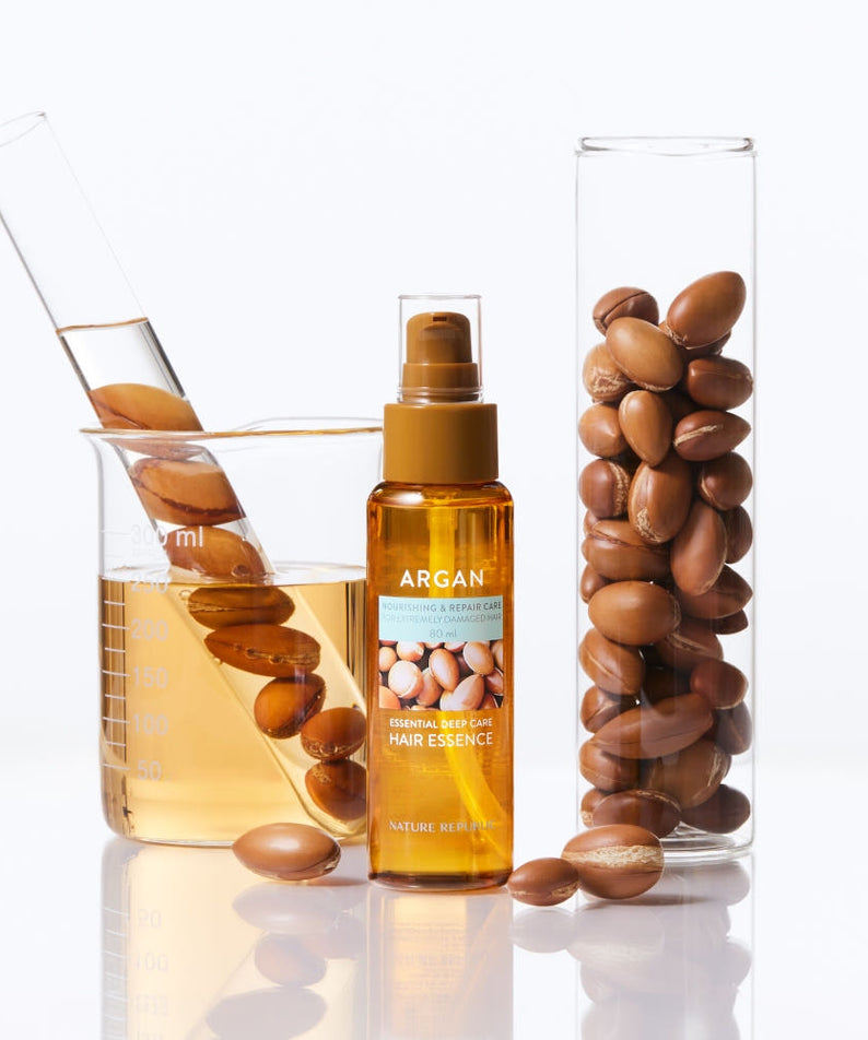 Flacon de 80ml de NATURE REPUBLIC Essential Deep Care Hair Essence avec noix d'argan et éprouvettes de laboratoire, soin capillaire.