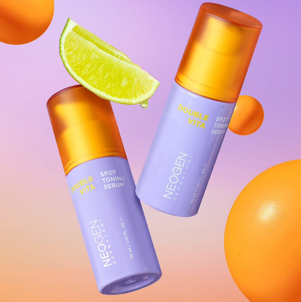NEOGEN Double Vita Spot Toning Serum 30ml, marque NEOGEN, sur fond violet avec tranches d’orange et de citron.