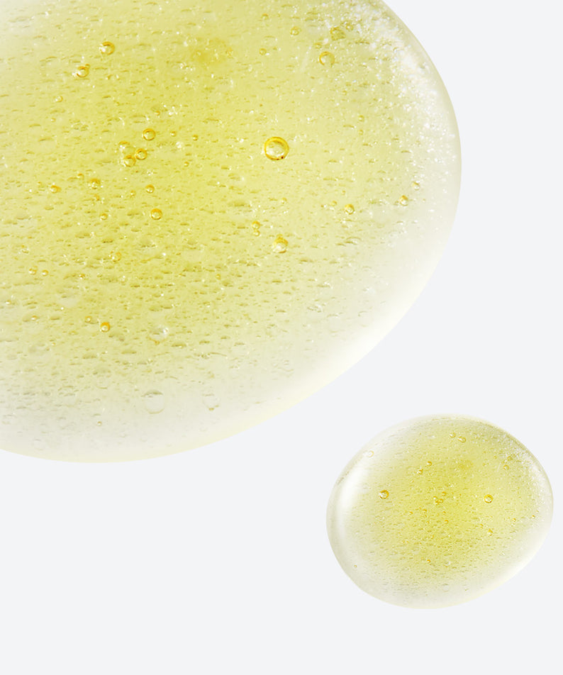 NEOGEN White Truffle Ampoule Drop Mist 80ml de NEOGEN : gouttelettes jaunes sur fond clair, effet ampoule blanc à la truffe