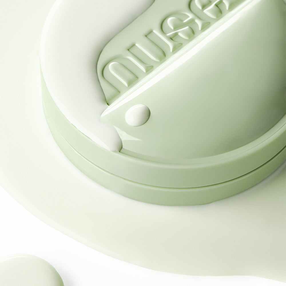 NUSE 1+1 Reju Toning Sun Cushion de NUSe, gros plan sur le coussin vert, texture crème et lumière douce.