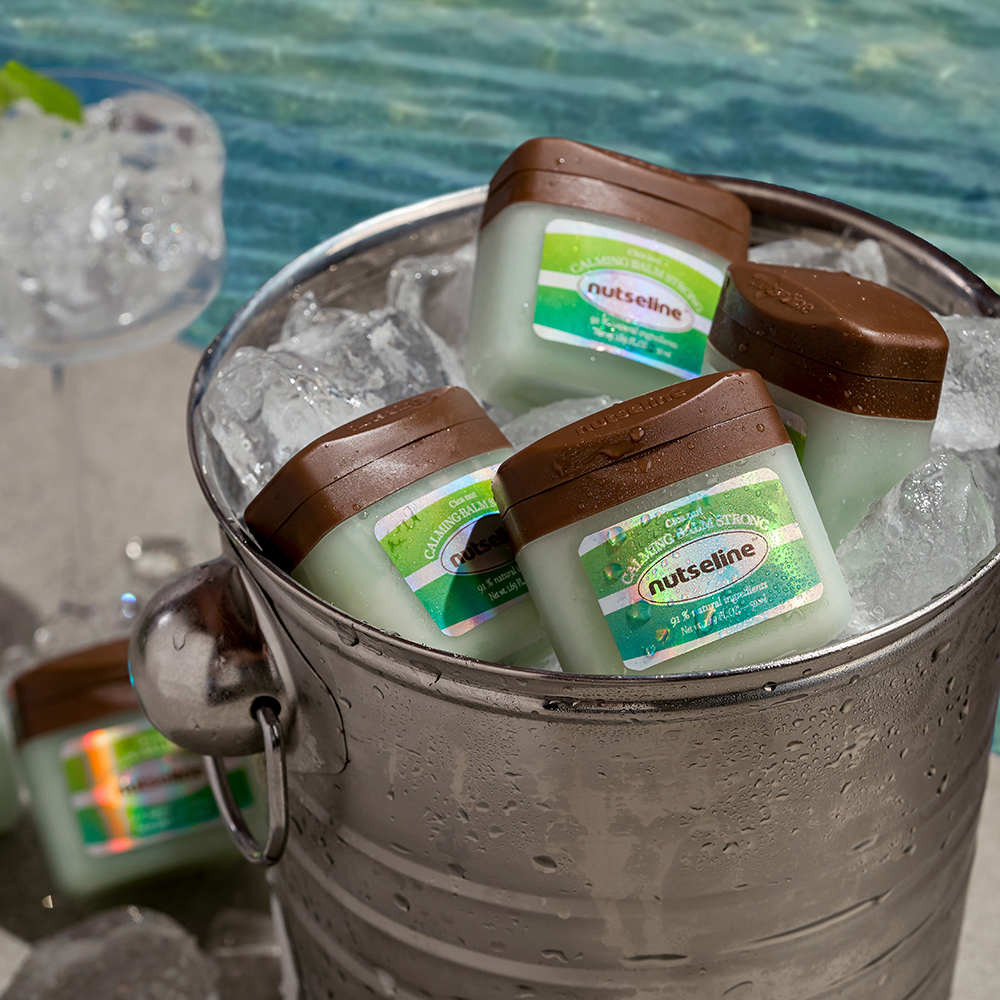 NUTSELINE Cica Nut Calming Balm Strong 50ml, baume calmant NUTSELINE en pack, posé sur glace, ambiance spa.