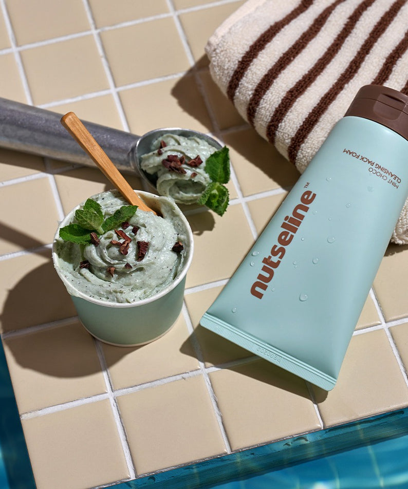 NUTSELINE Mint Chocolate Cleansing Pack Foam 130g, marque sur tube menthe-chocolat près d’une mousse verte en salle de bain