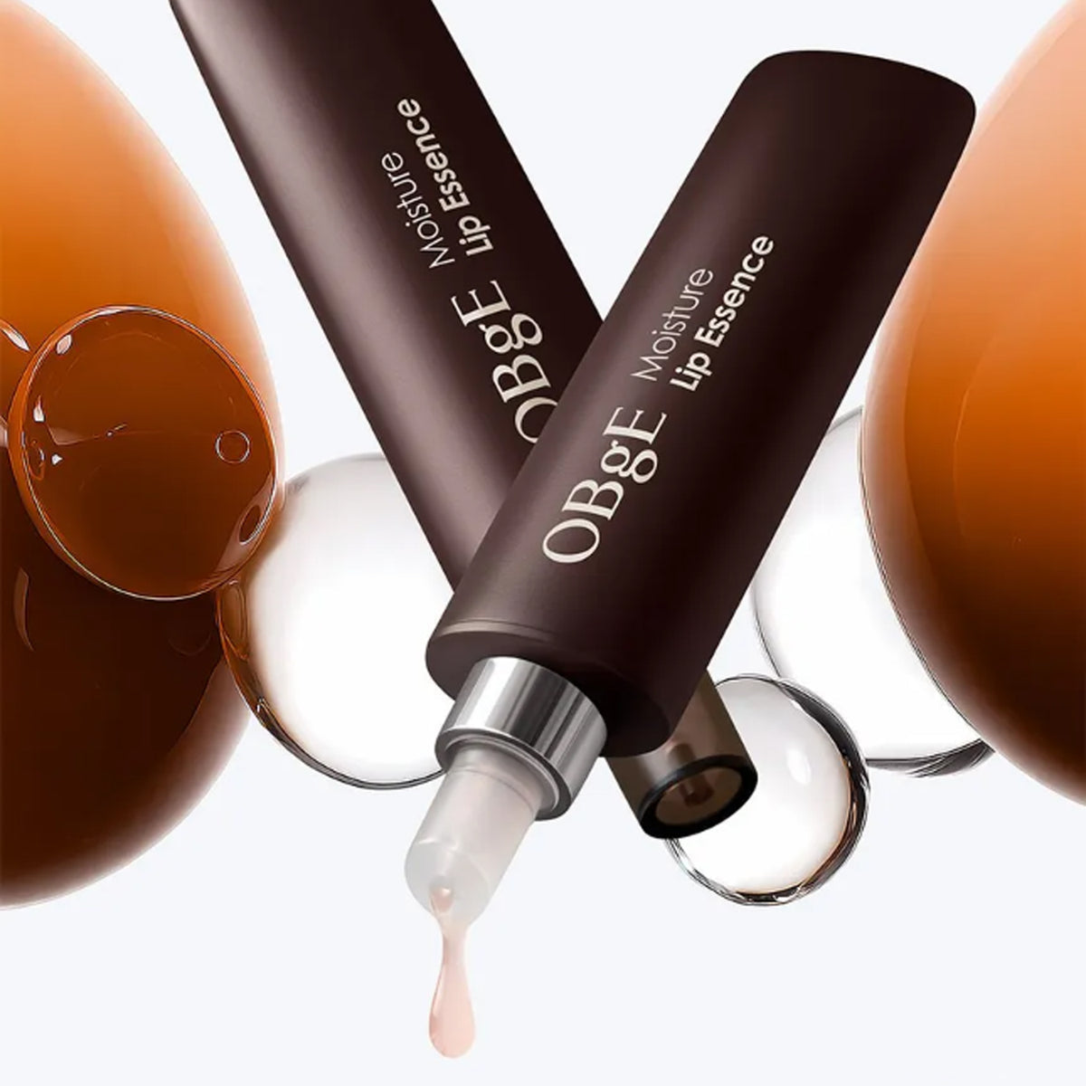 OBGE Moisture Lip Essence 10ml, marque OBGE, tube brun sur fond clair avec goutte de texture, vue produit