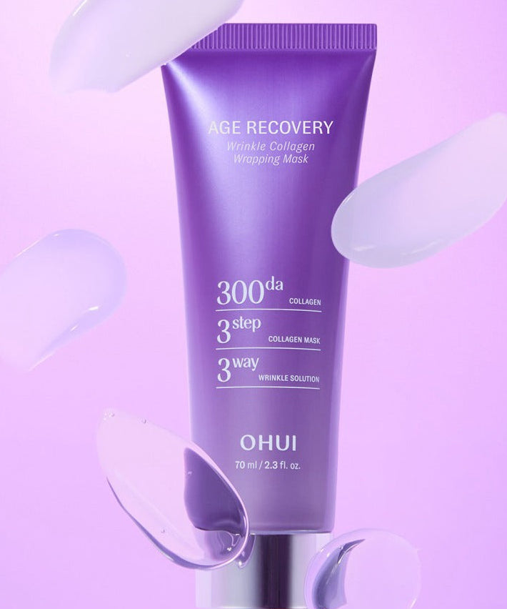 OHUI Age Recovery Collagen Wrapping Mask 70ml : tube violet sur fond rose, application de masque cosmétique anti-âge.