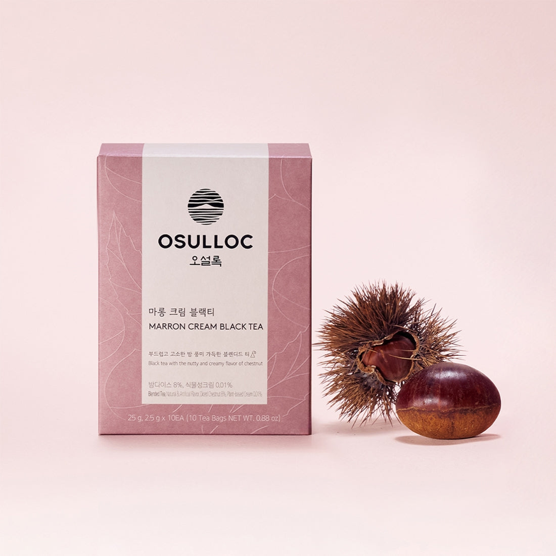OSULLOC Marron Cream Black Tea 10 p, boîte marron crème sur fond rose, marque OSULLOC et châtaigne décorative.