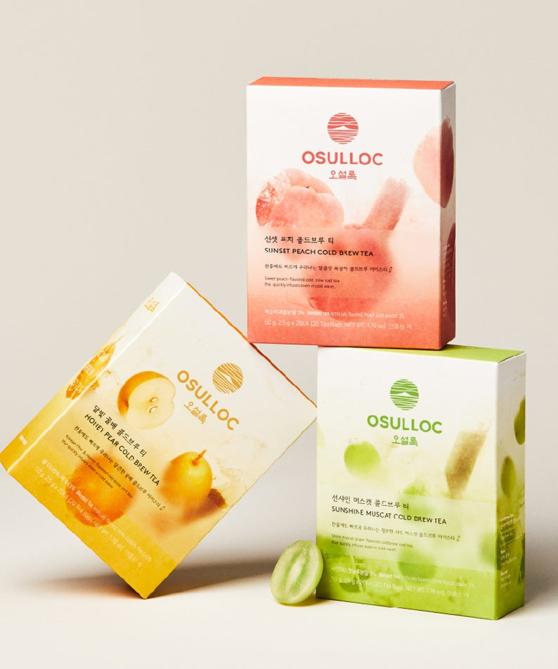 Boîtes de thé glacé OSULLOC Sunset Peach Cold Brew Tea 20 P empilées, illustrant l'arôme de pêche et les saveurs rafraîchissantes.