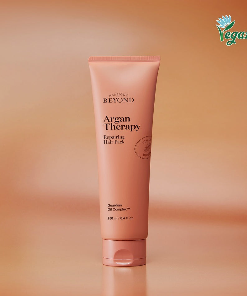 PASSION & BEYOND Argan Therapy Repairing Hair Pack 250ml, tube de soin cheveux sur fond orange, produit de la marque.