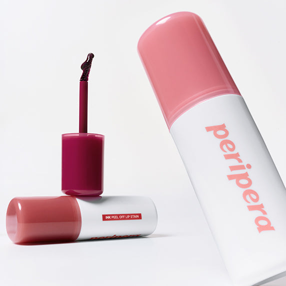 PERIPERA Ink Peel-Off Lip Stain de la marque PERIPERA, flacons et tube rose en studio sur fond clair.