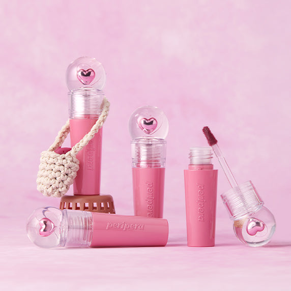 PERIPERA Ink The Gellable Tint de la marque PERIPERA, présentée en maquillage rose sur fond pastel, avec applicateur