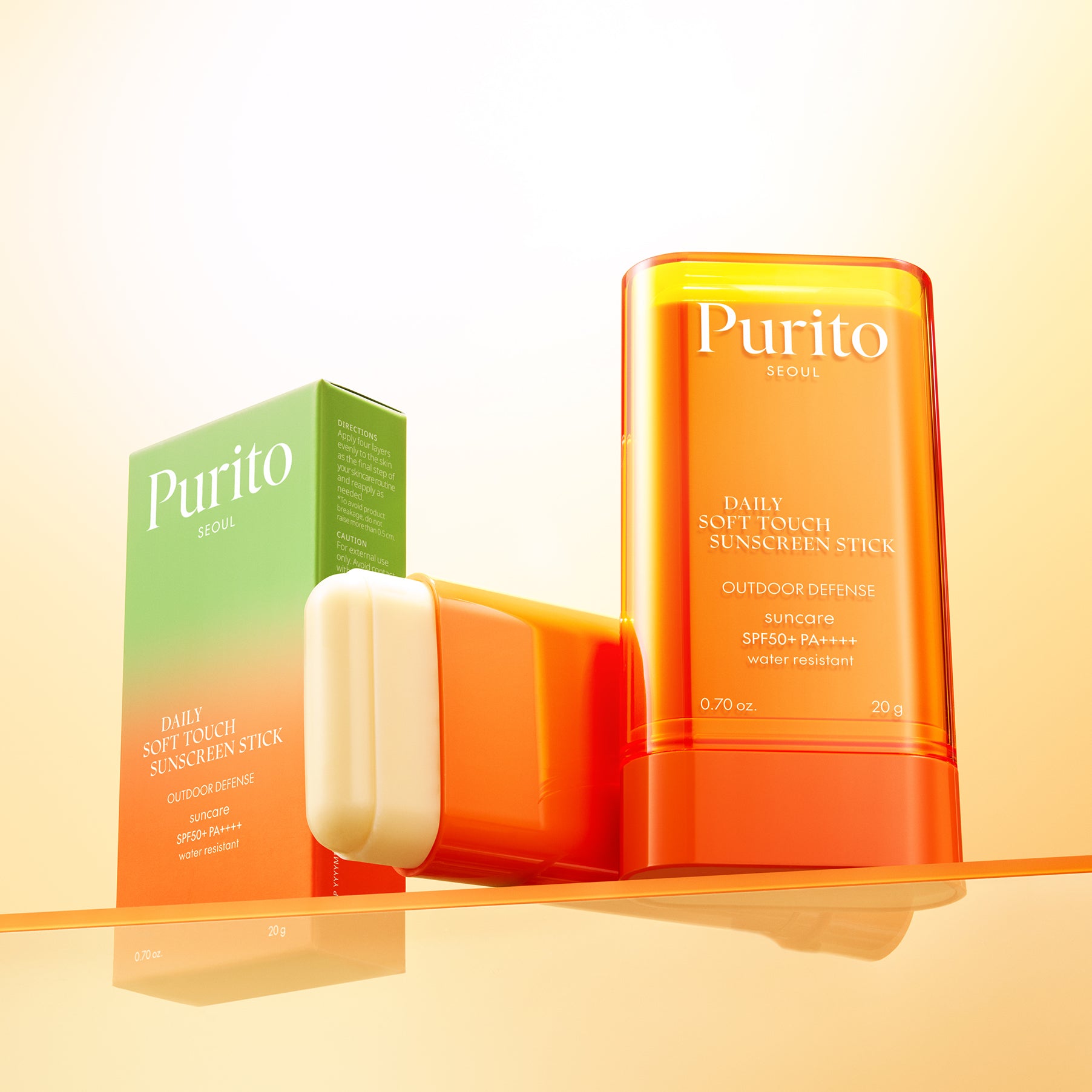 PURITO Daily Soft Touch Sun Stick SPF50+PA++++ de Purito, stick solaire orange et blanc sur fond clair, contexte beauté