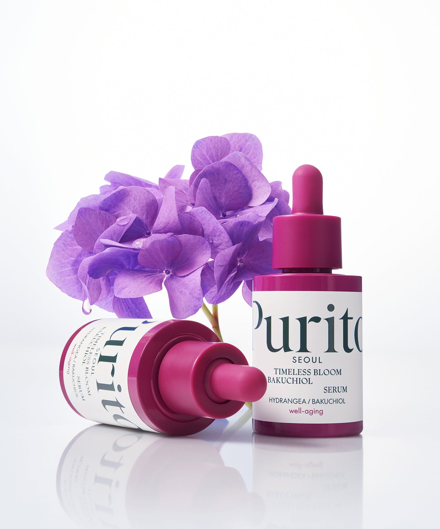 PURITO Timeless Bloom Bakuchiol Serum 30ml de Purito sur fond blanc avec fleurs violettes et sérum