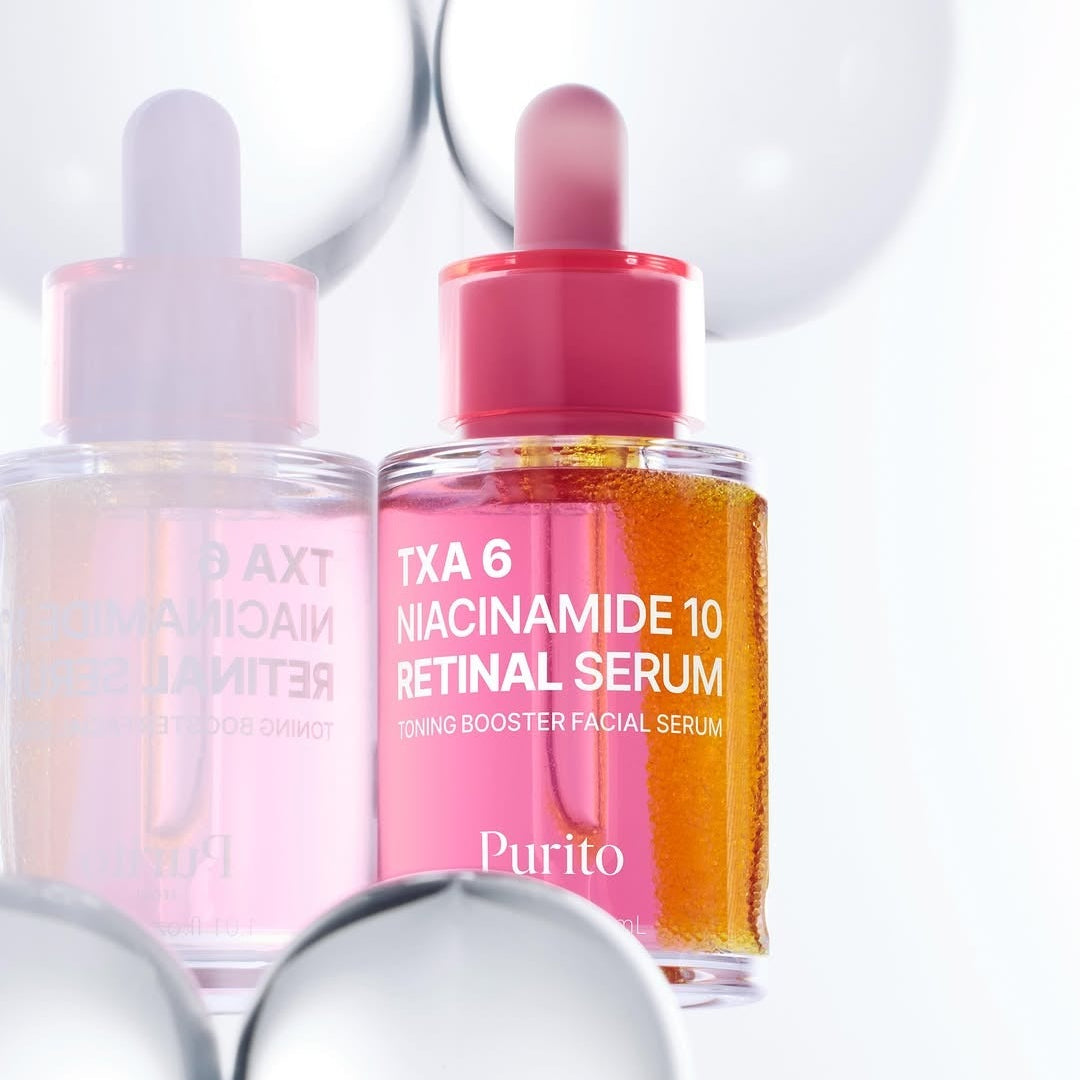 Décris l'image en français : PURITO Tranexamic Acid 6 Niacinamide 10 Retinal Serum 30ml, flacons rosés, sur fond blanc.