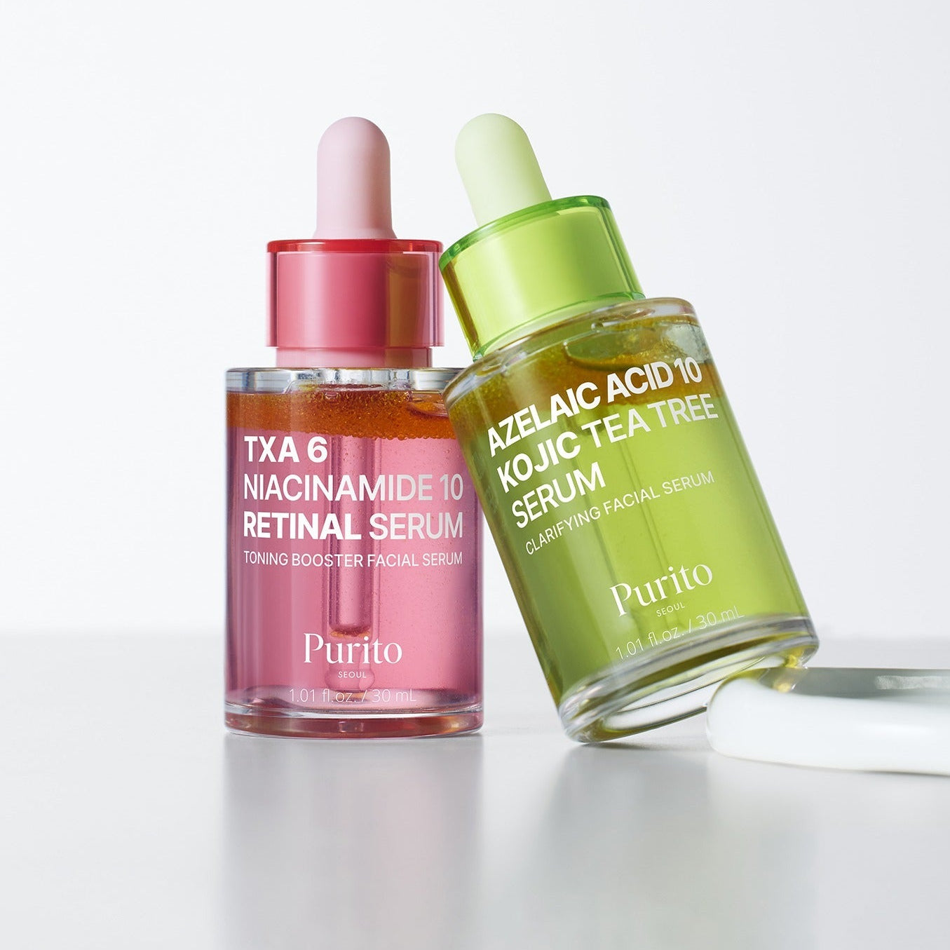 PURITO Tranexamic Acid 6 Niacinamide 10 Retinal Serum 30ml de Purito, flacons rose et vert sur fond blanc, contexte beauté