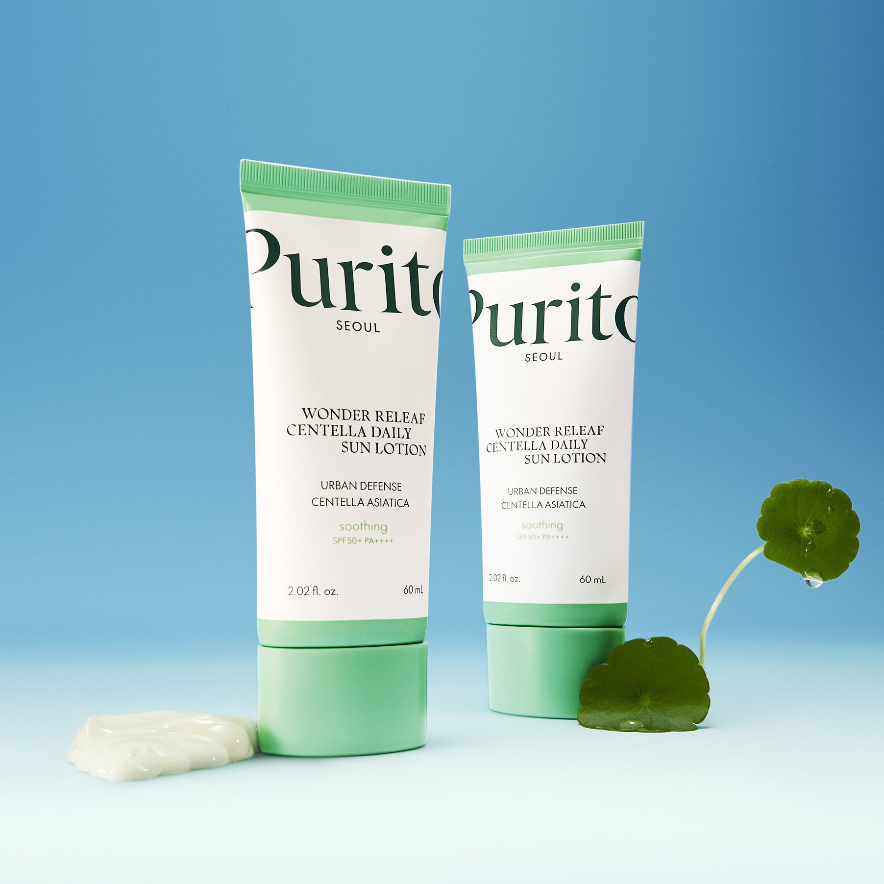 PURITO Wonder Releaf Centella Daily Sun Lotion SPF50+PA++++ de Purito, flacons sur fond bleu avec feuilles vertes.