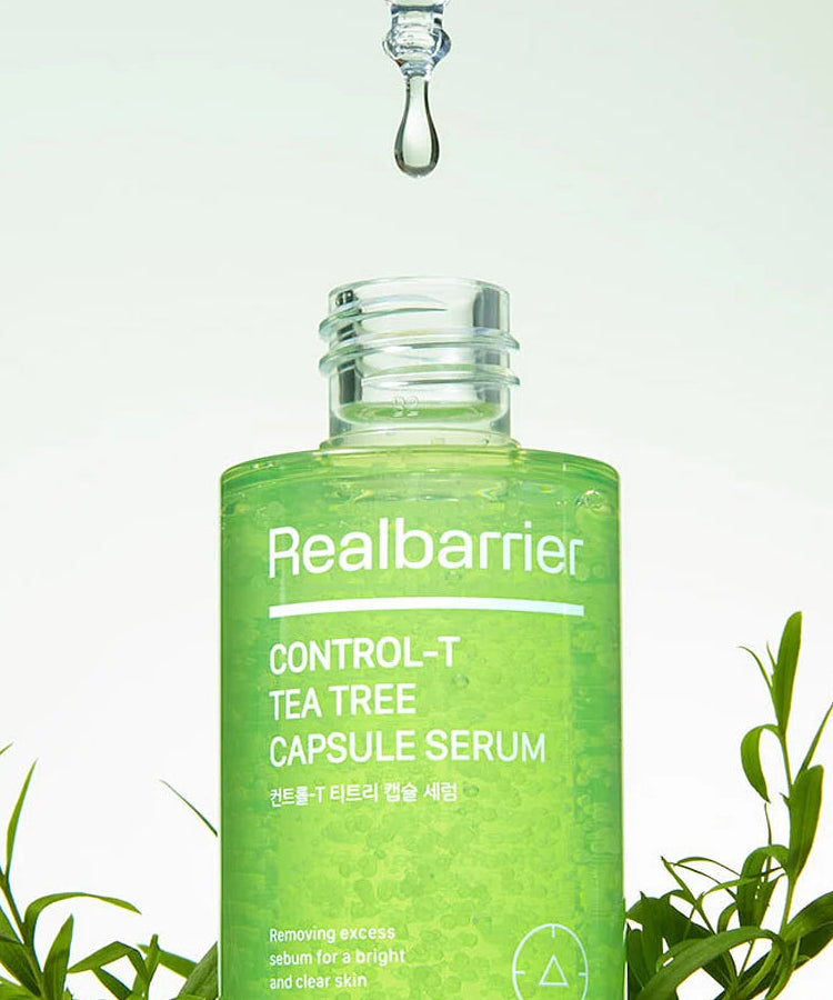 REAL BARRIER Control-T Tea Tree Capsule Serum 30ml de la marque Realbarrier, flacon vert avec théier, goutte sur fond clair.