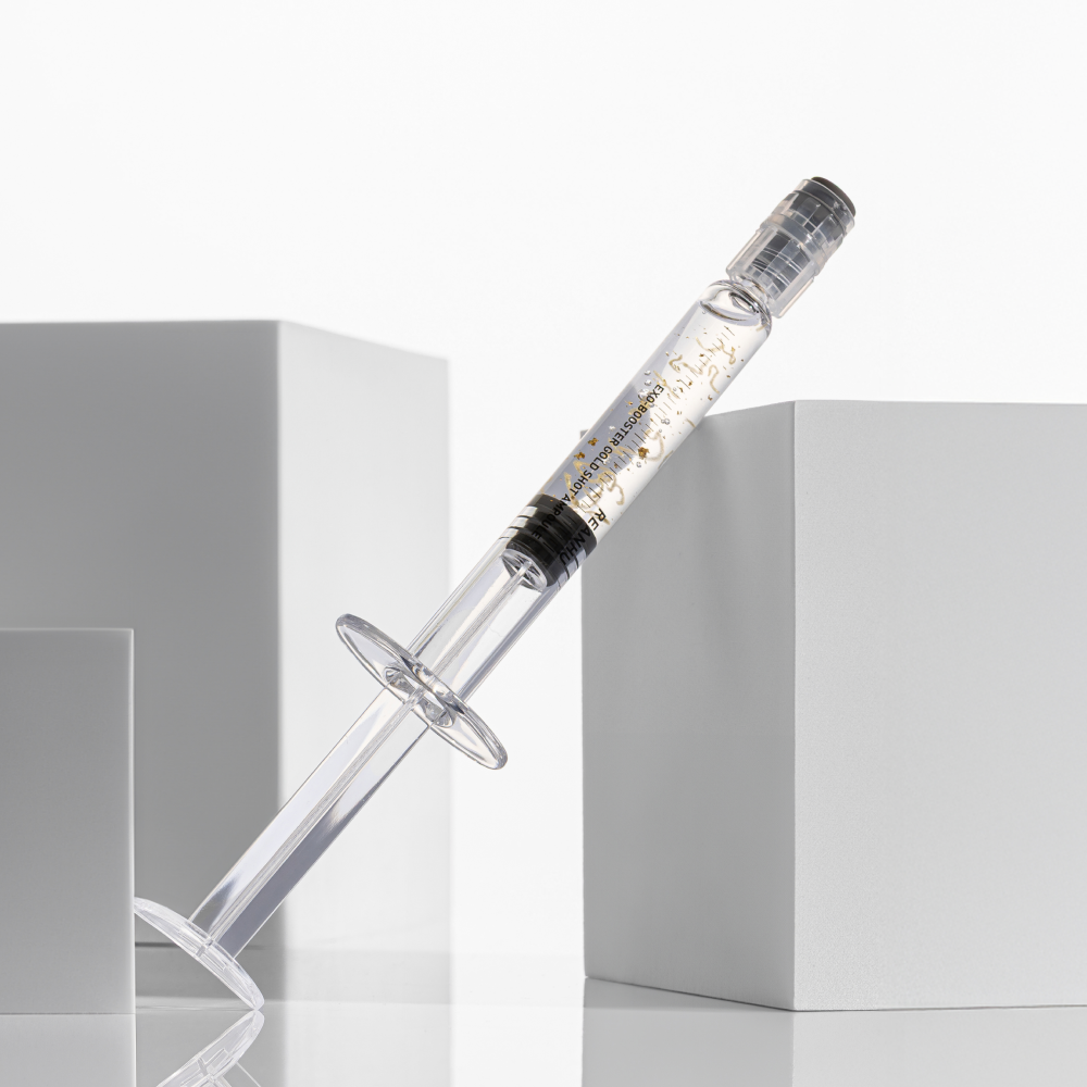 REANHU Exo Booster Gold Shot Ampoule 2 g X 7 ea, fiole ambrée dorée, flacon sur fond blanc, mise en scène produit