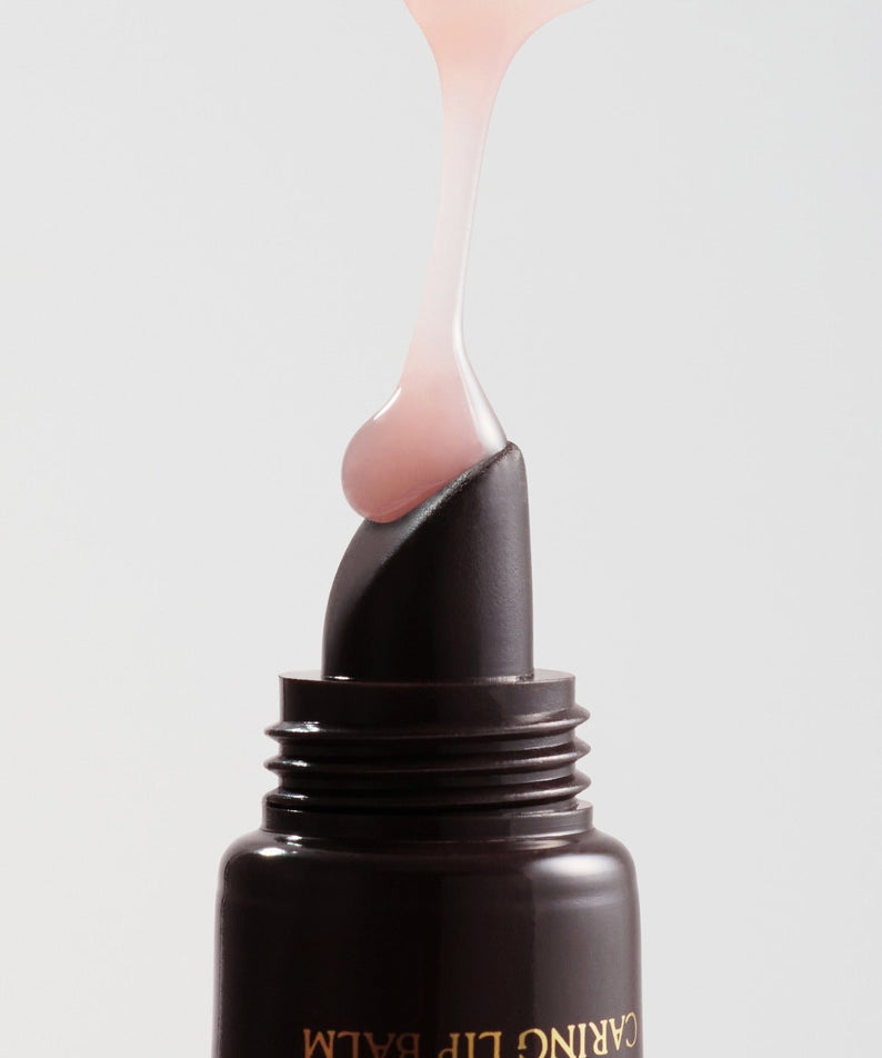 RULIDIA Shining Moment Caring Lip Balm 8g sur fond blanc, baume lèvres éclatant et hydratant, texture douce et nourrissante.